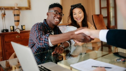 a person shaking hands with a landlord before signing a lease