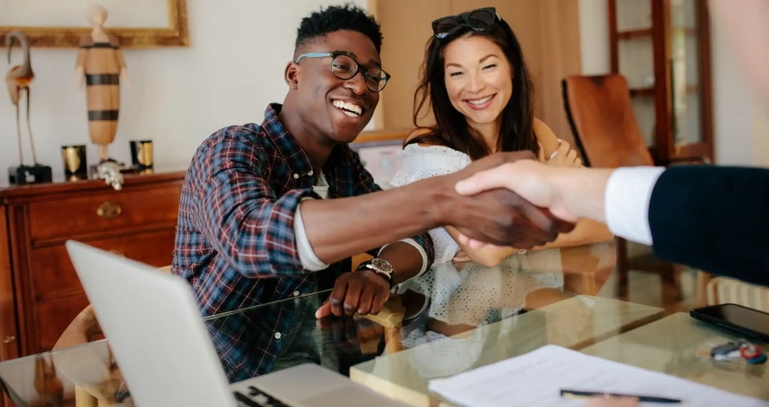 a person shaking hands with a landlord before signing a lease