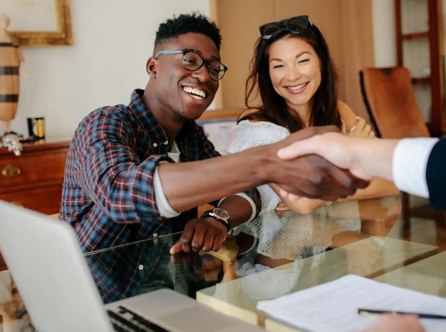 a person shaking hands with a landlord before signing a lease