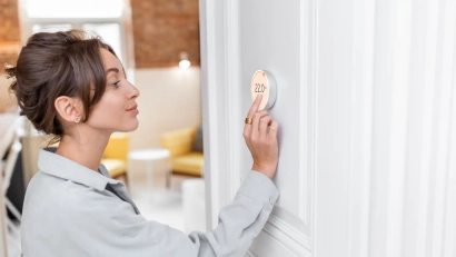 a person adjusting the thermostat