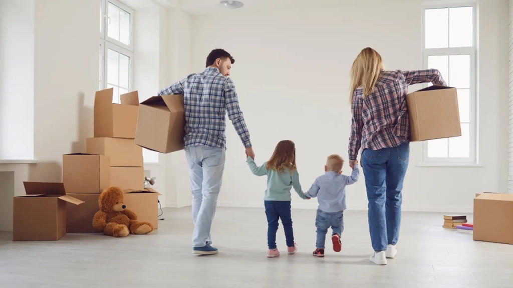 a family moving in an empty house with moving boxes lying around