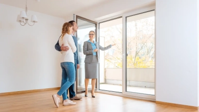 A realtor showing a houseto a couple