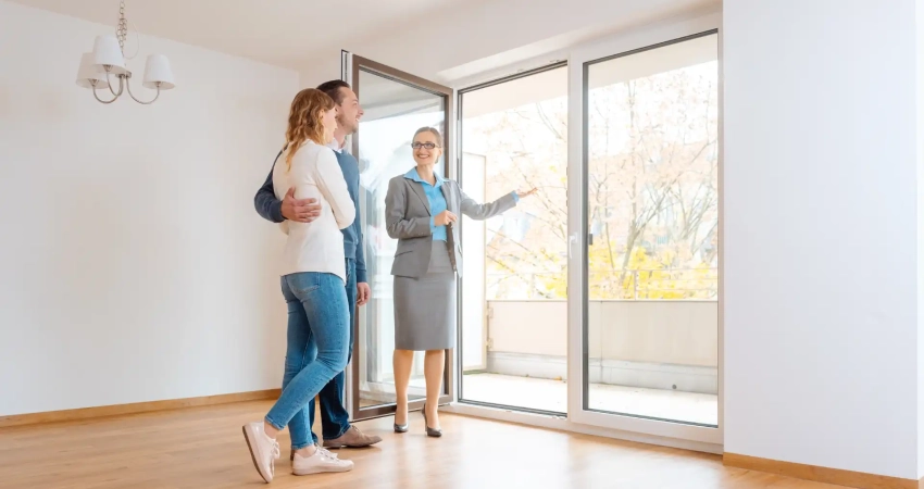 A realtor showing a houseto a couple