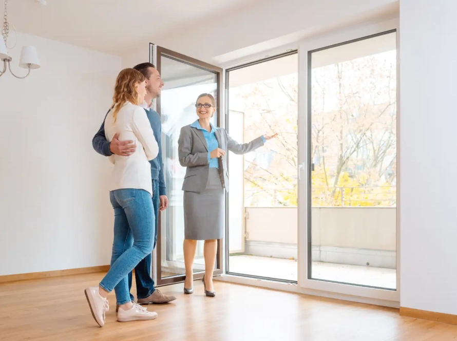 A realtor showing a houseto a couple